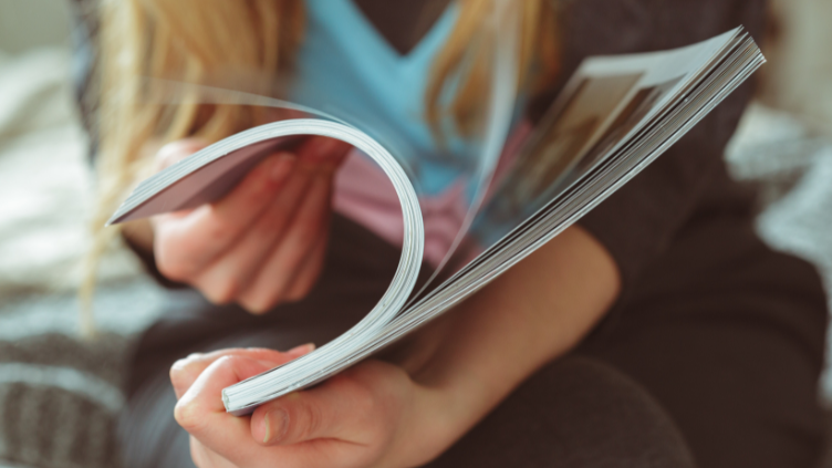 A woman flipping through a magazine